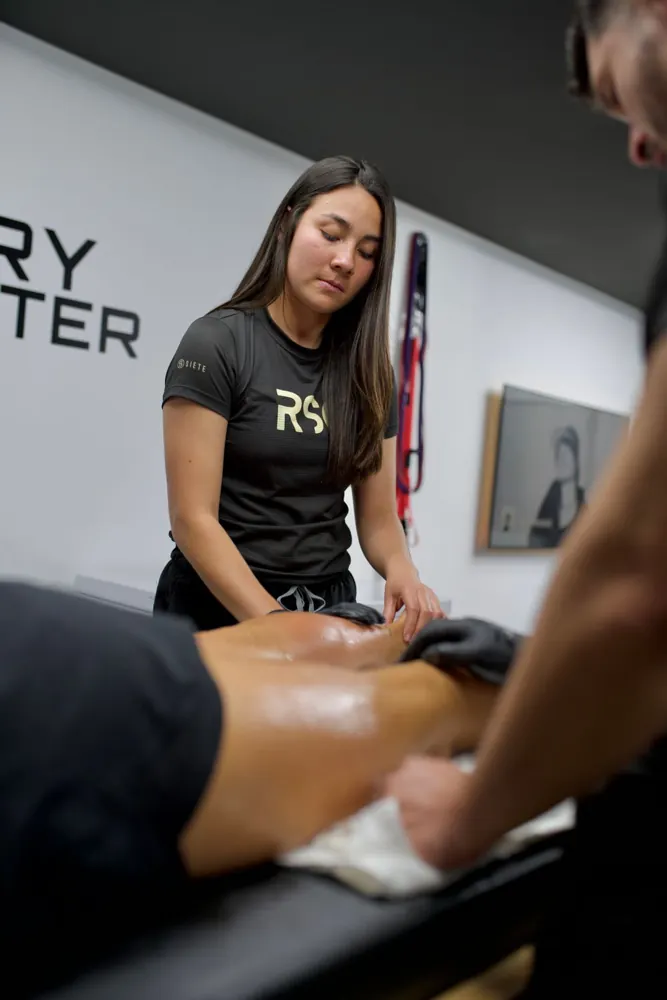 Practitioner carrying out a lower-leg treatment