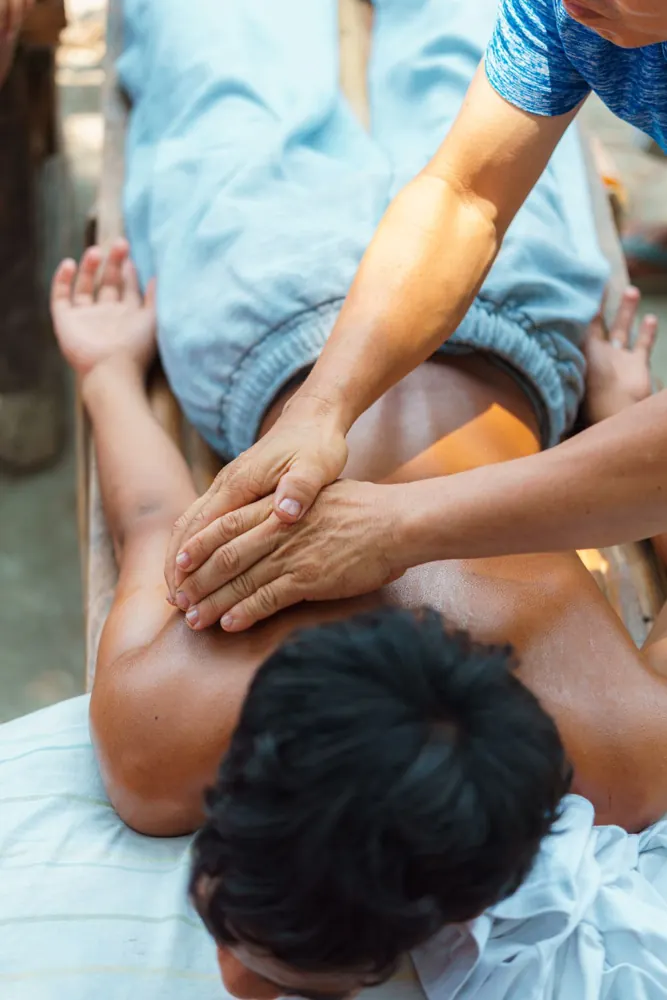Overhead view of a male client receiving a back massage
