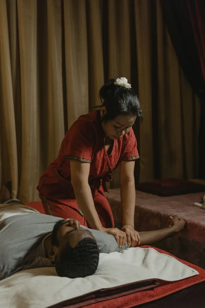 Spa practitioner attending to a reclining male client
