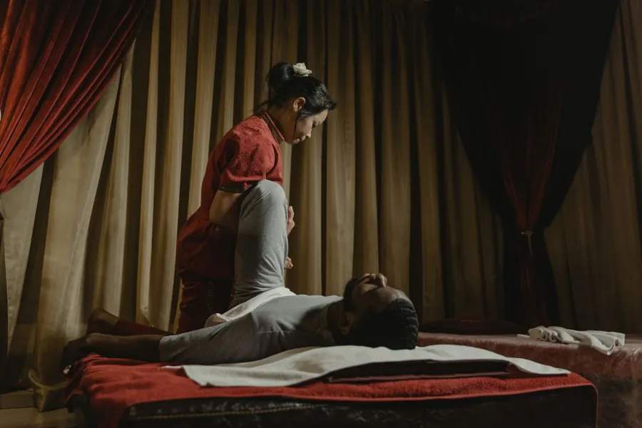 Practitioner preparing a covered male client for a session